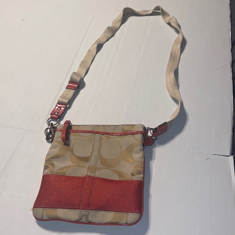 Tan and burnt orange Coach crossbody bag.